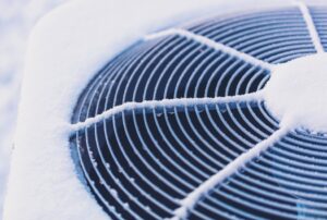 Close-up of an air conditioning unit covered in frost, illustrating the challenges of frozen AC systems during cold weather and the need for professional troubleshooting and repair by Family Heating and Cooling in Westport, Dartmouth, and nearby areas. Frozen Air Conditioner, AC Repair, HVAC Services, Winter HVAC Maintenance, AC Troubleshooting, AC Frozen Westport, AC Maintenance Dartmouth, Air Conditioning Issues Fall River, Frozen AC Solutions New Bedford, Family Heating and Cooling Marion, Residential HVAC Services Fairhaven